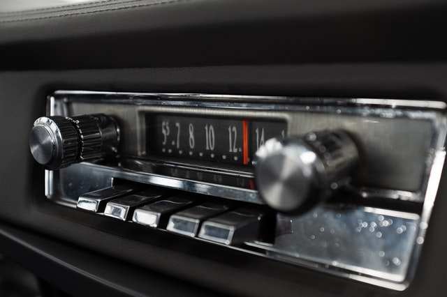 An old car radio with push-in buttons to change station